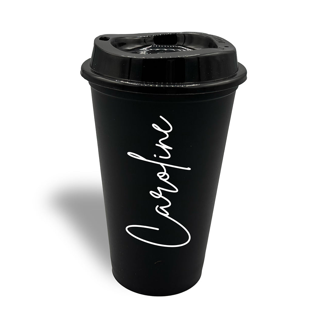 Black plastic travel cup with lid, decorated with a signature style font in the name of Caroline