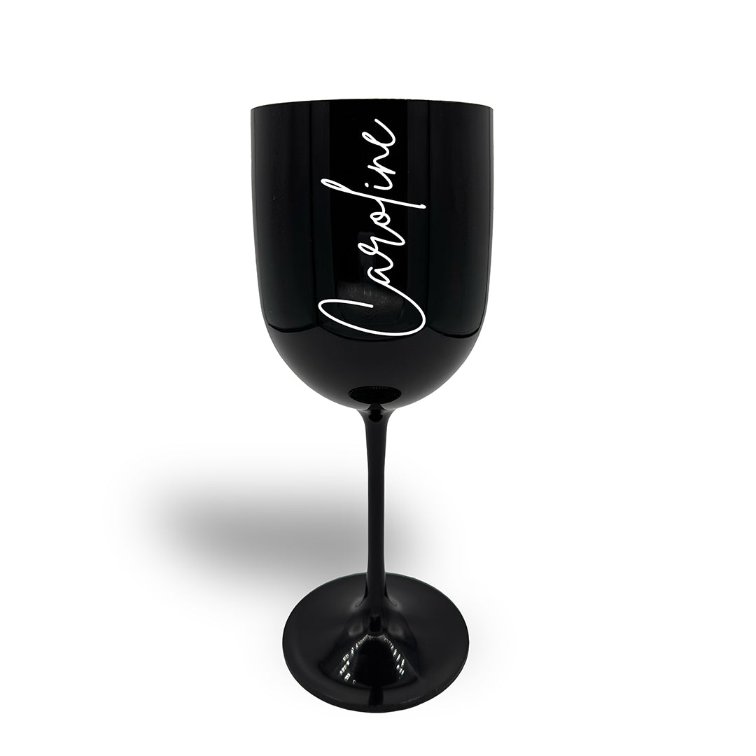 Large black plastic wine glass decorated in white text with the name Caroline in a signature font