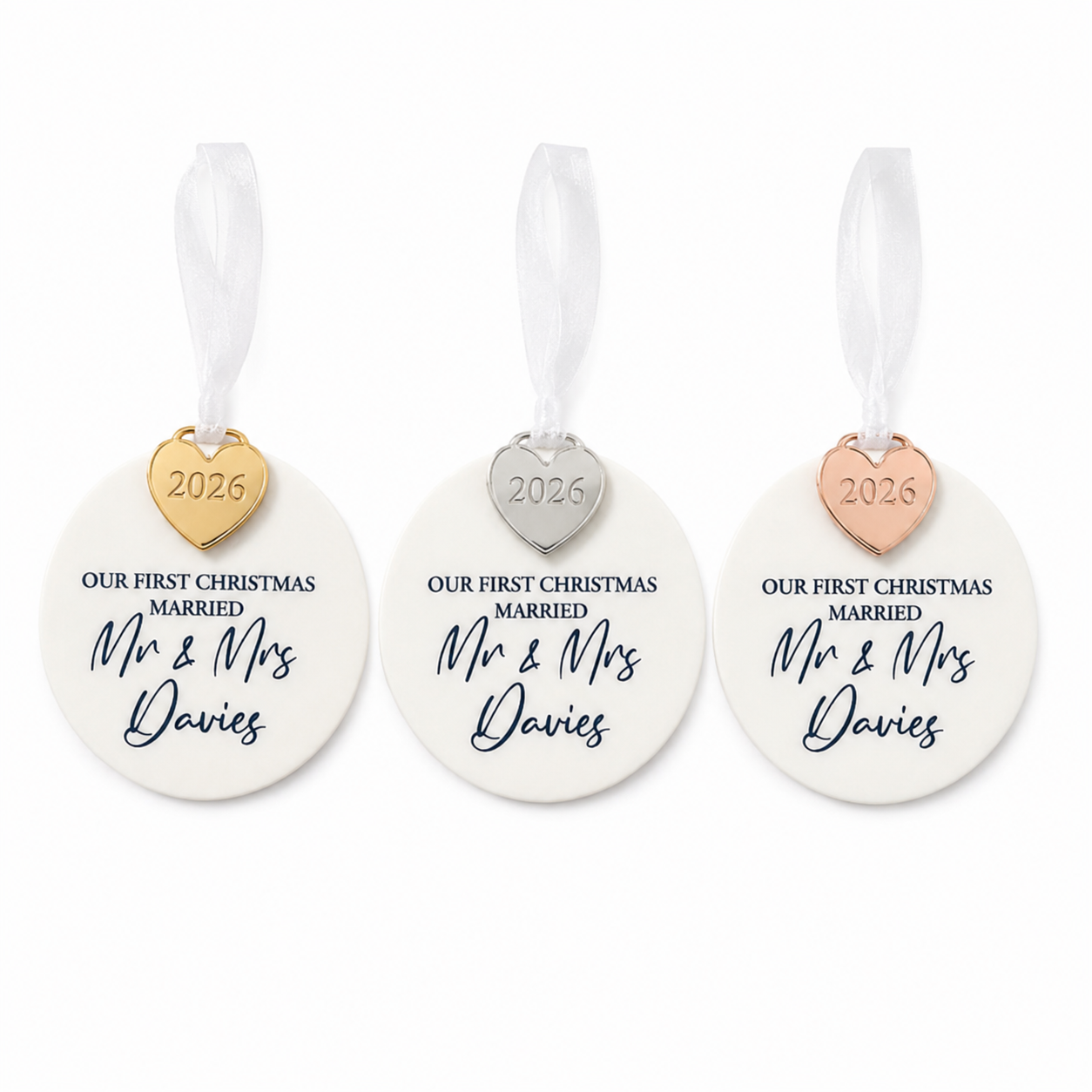 Three 'Our First Christmas Married' ornaments with heart-shaped tags on a white background