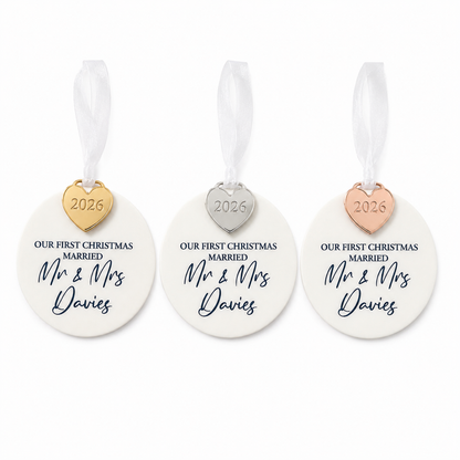 Three 'Our First Christmas Married' ornaments with heart-shaped tags on a white background