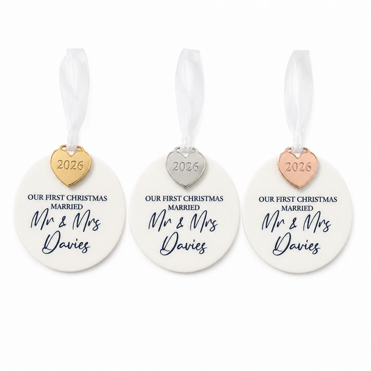 Three 'Our First Christmas Married' ornaments with heart-shaped tags on a white background