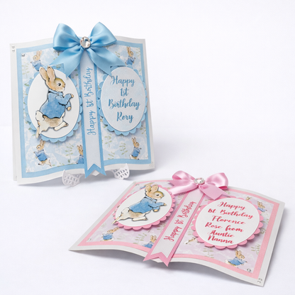 Two birthday cards for a child's 1st birthday with cartoon character and ribbons on a white background.