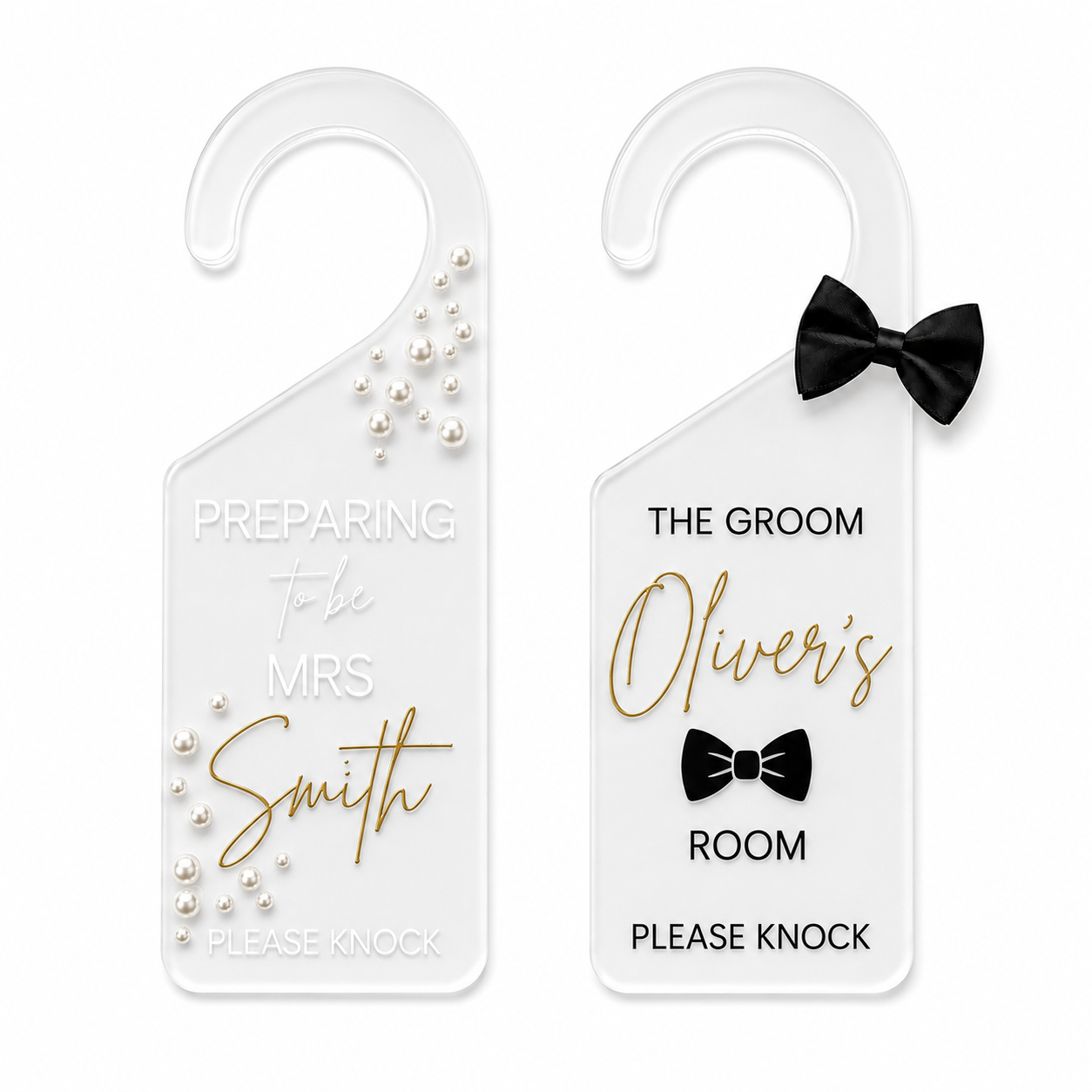 Two personalized white plastic door hangers shown on a plain white background. The left hanger is for 'The Bride' with gold script text and pearl embellishments, and the right hanger is for 'The Groom' with gold script text, a black bow tie graphic, and a black bow tie decoration.