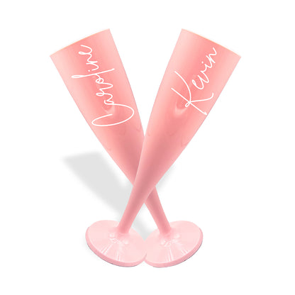 Pair of pink plastic champagne flutes in a cross formation, personalised in a pink signature font