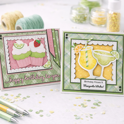 Two birthday cards with decorative elements on a table with confetti and pens.