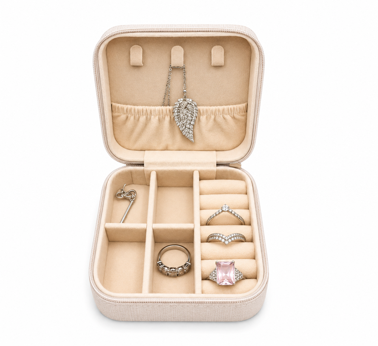 An open beige jewelry organizer box with multiple compartments, holding several rings and a necklace, photographed on a clean white background.