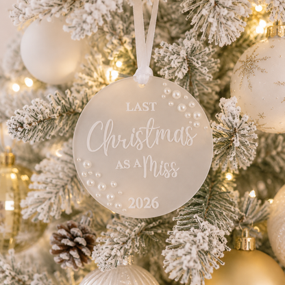 Decorative ornament on a Christmas tree with 'Last Christmas as a Miss 2026' text.