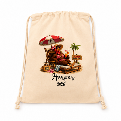 A beige drawstring bag with a custom beach-themed graphic of a relaxing bear under a red and white umbrella, with the text 'Harper 2026' printed below, shown on a clean white background.