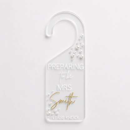 Door hanger with 'Preparing to be Mrs Smith' text on a white background