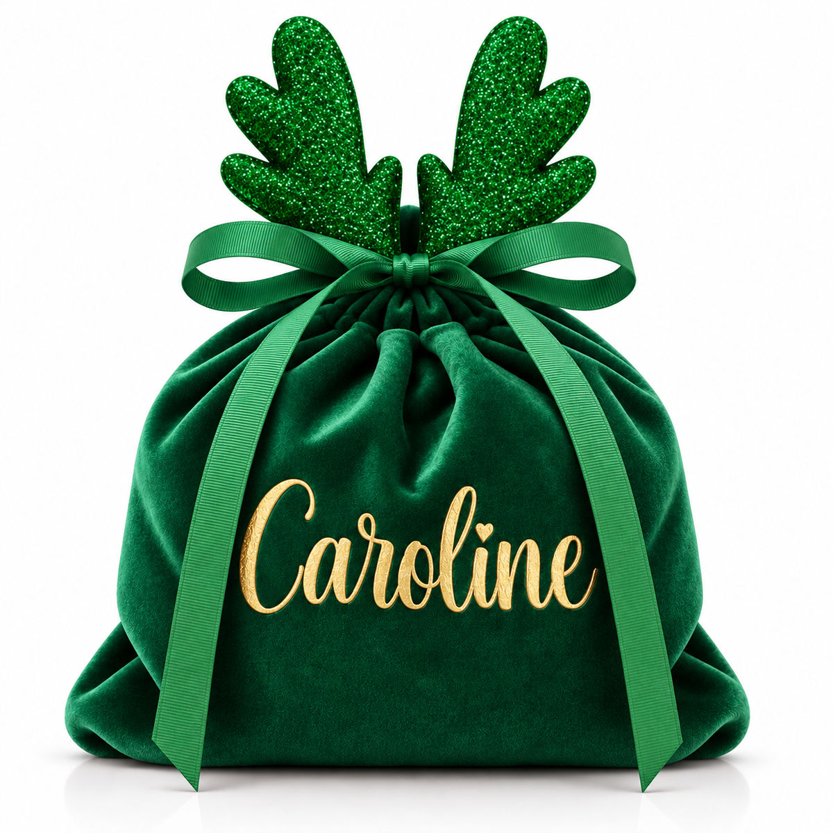A personalized green velvet Christmas gift bag with glittery green reindeer antlers, a green ribbon bow, and the name 'Caroline' in gold script on the front, set against a plain white background.
