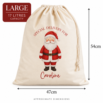 A large cream-colored canvas Christmas sack with a drawstring closure, featuring a printed illustration of Santa Claus and the text 'SPECIAL DELIVERY FOR Caroline'. The image includes dimension markers showing a height of 54cm and a width of 47cm, with a red badge in the top left corner indicating 'LARGE 17 LITRES CAPACITY'.