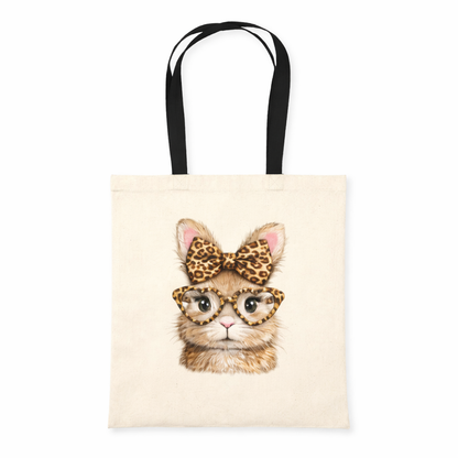 Tote bag with a cat wearing a leopard print bow and glasses on a beige background