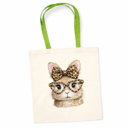 Tote bag with a bunny illustration wearing glasses and a leopard print bow, green handles.