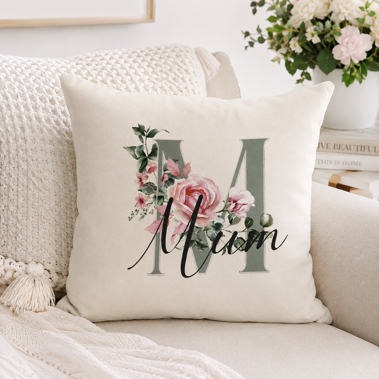 Decorative pillow with floral design and 'Mom' text on a couch.