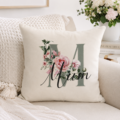 Decorative pillow with floral design and 'Mom' text on a couch.