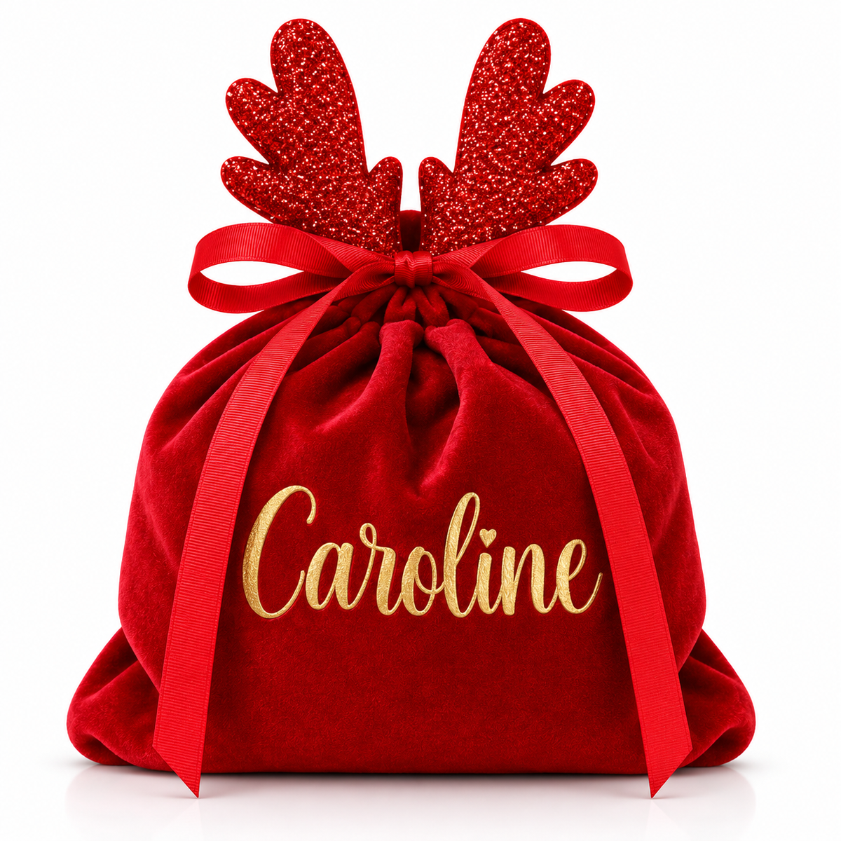 A personalized red velvet Christmas gift sack with red glitter reindeer antlers, a red ribbon bow, and the name 'Caroline' embroidered in gold script on the front, set against a plain white background.