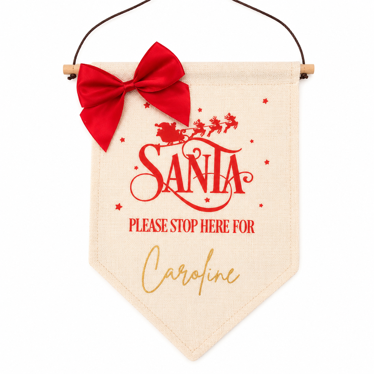 Decorative sign with 'Santa Please Stop Here For Caroline' text and red bow on a white background