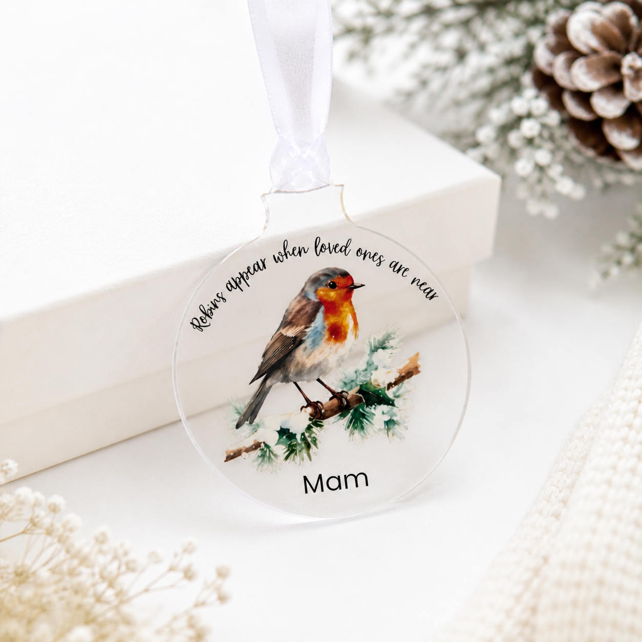 Decorative ornament with a robin illustration and text on a white background