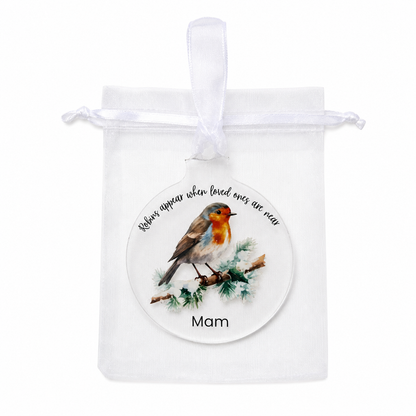 Decorative ornament with a robin and engraved text on a white background