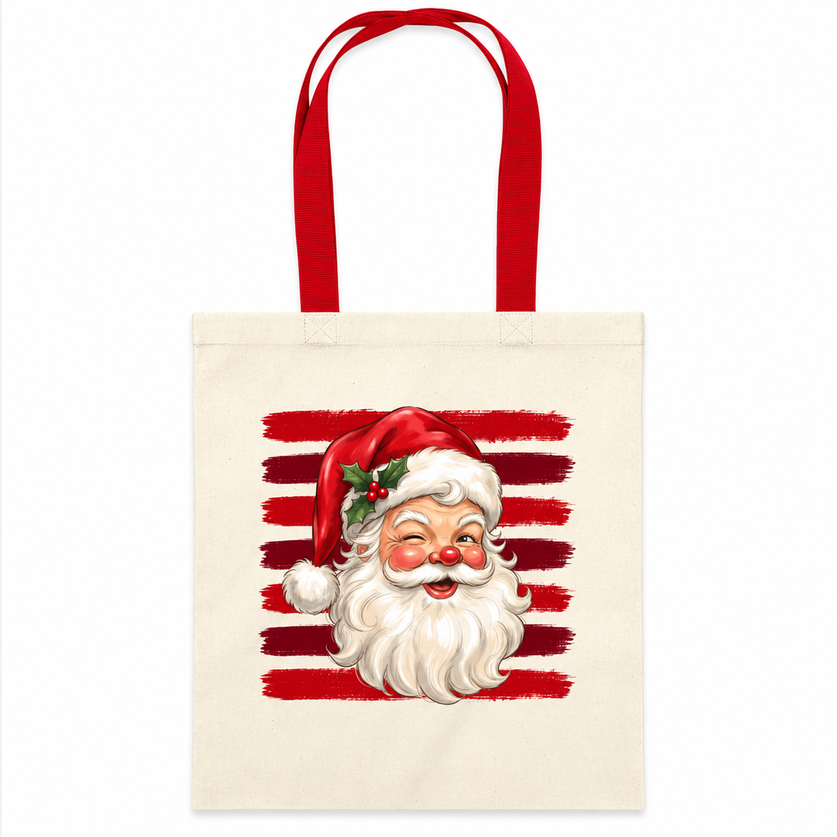 A cream canvas tote bag with red handles, featuring a graphic print of a smiling Santa Claus face in front of red horizontal brushstroke stripes.