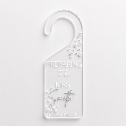 Door hanger with 'Preparing To Be Mrs Smith' text on a white background