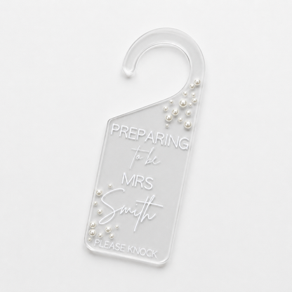 Clear door hanger with 'Preparing to be Mrs Smith' text and pearl embellishments on a white background